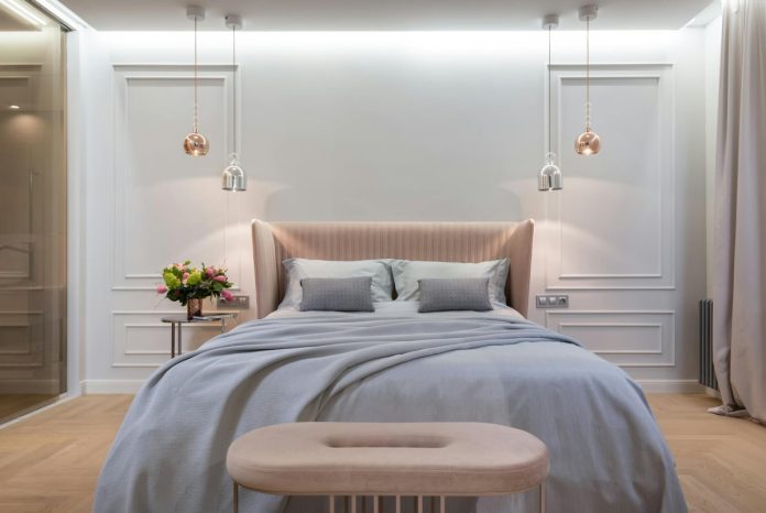 bedroom interior with bed near table under lamps