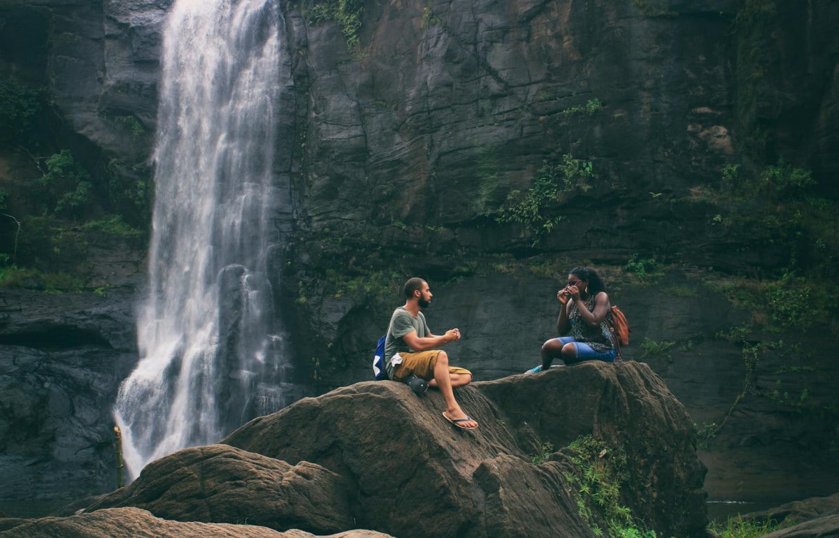 man and woman near waterfall relationship goals